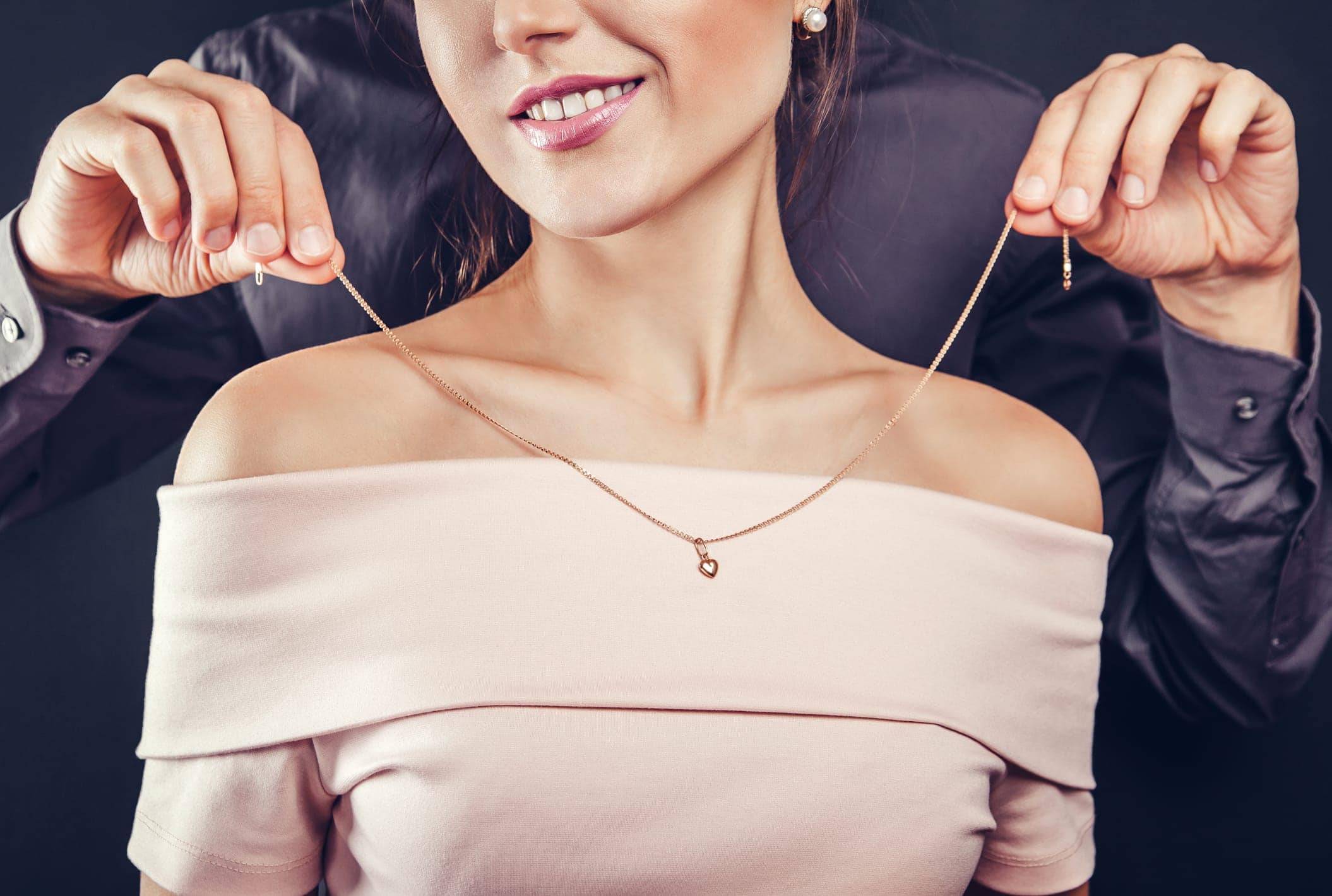 Man Putting A Necklace On Lovely Lady