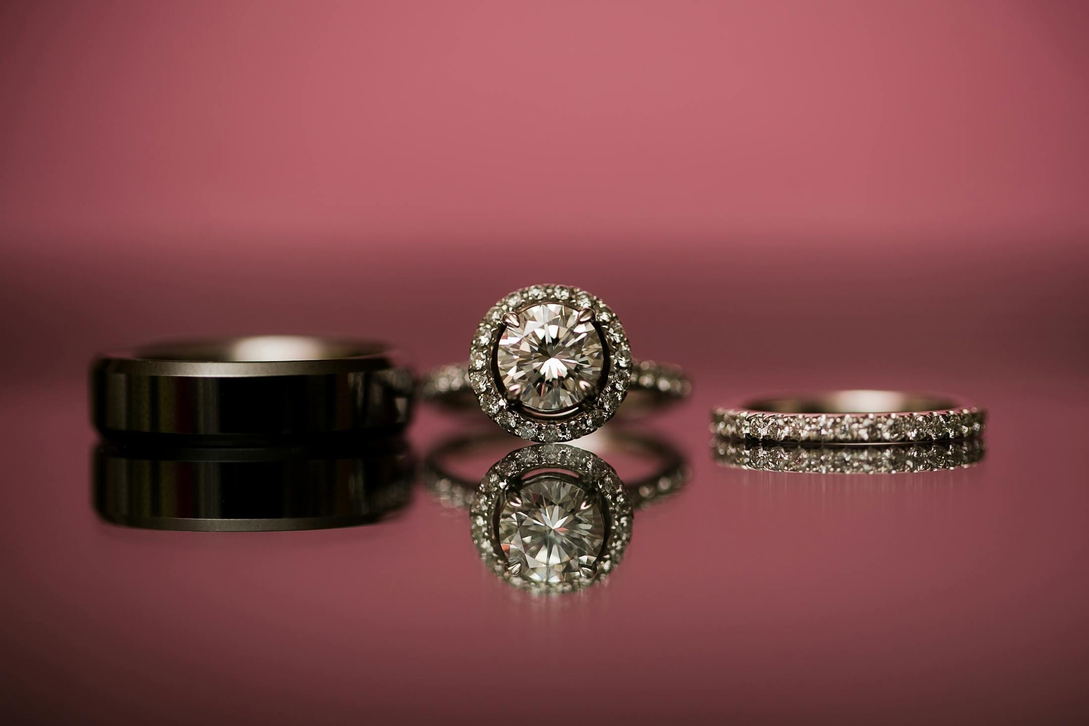 Simple wedding band worn beside an engagement ring on a hand