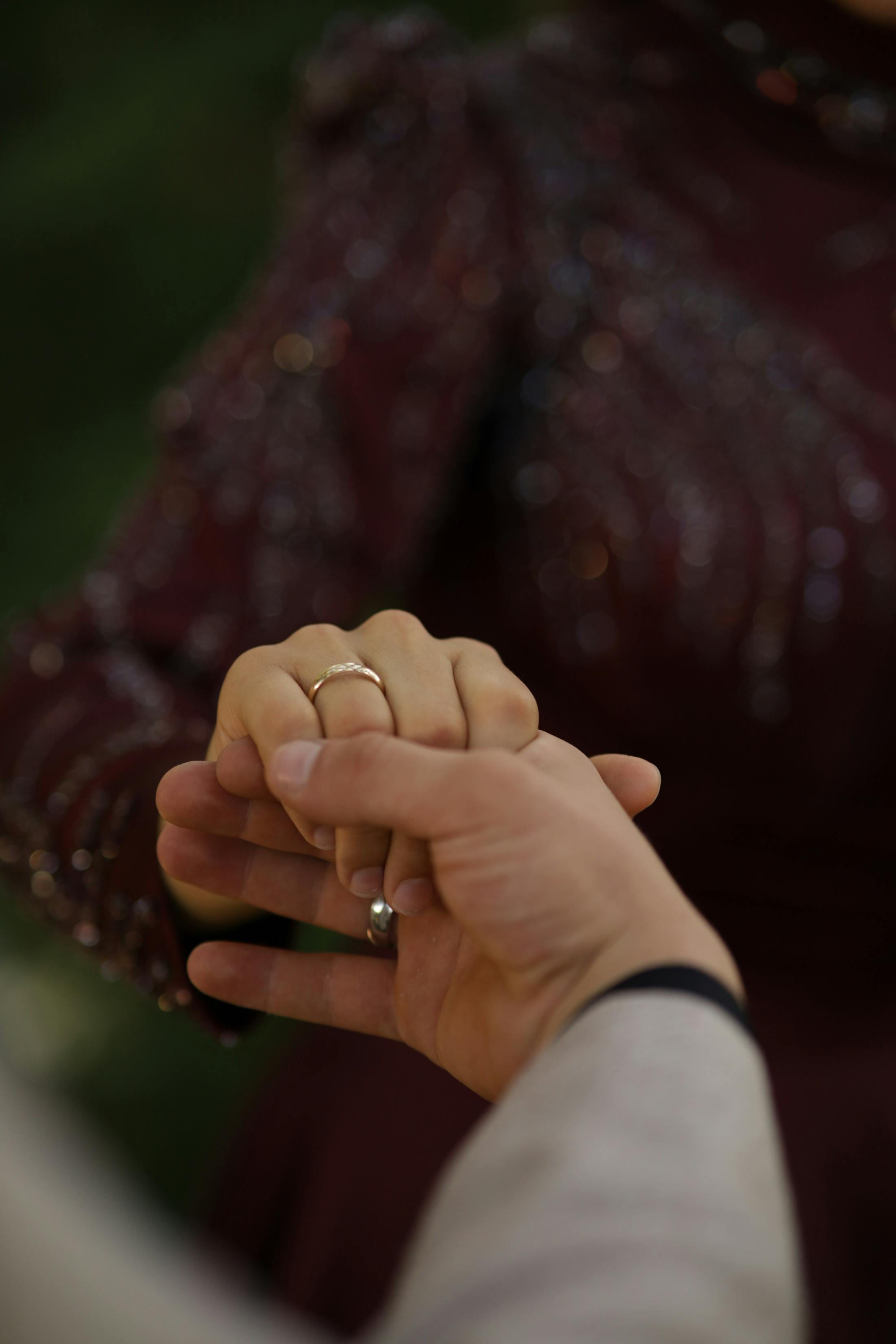 Couple trying on matching rings at a jewellery counter